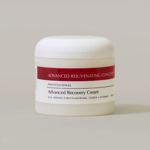 Jar of Advanced Recovery Cream with a red label on a beige background