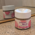 Jar of 'journee bloom' Glow Scrub on a countertop with a mirror in the background